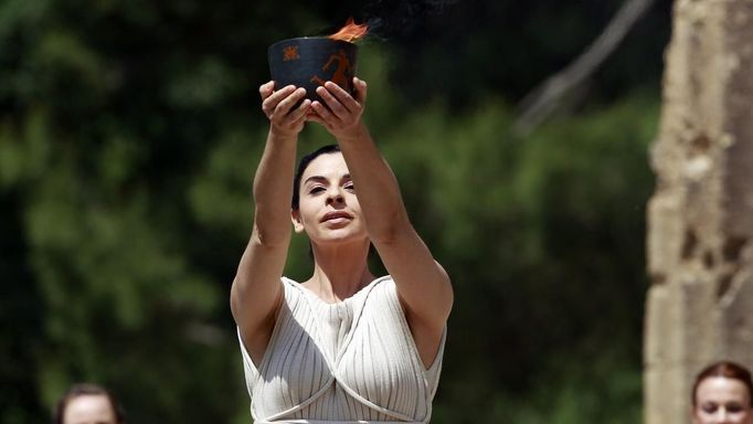 Greek actress Ino Menegaki, playing the role of High Priestess, holds up the cauldron with the Olympic flame during the torch lighting ceremony of the London 2012 Olympic