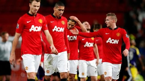 Manchester United players walk off the pitch after losing their English FA Cup soccer match against Swansea City at Old Trafford in Manchester