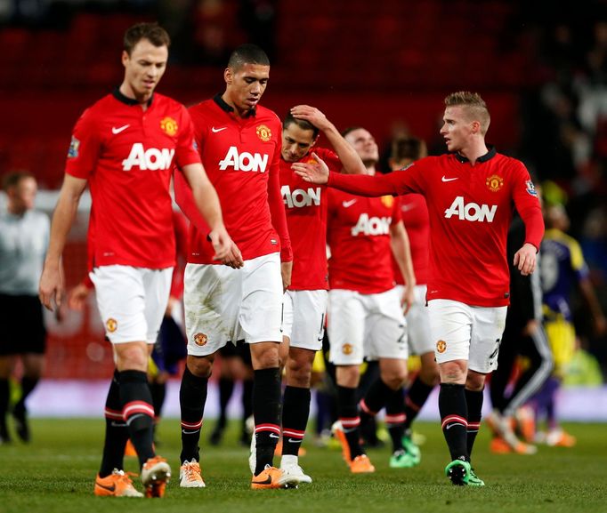 Manchester United players walk off the pitch after losing their English FA Cup soccer match against Swansea City at Old Trafford in Manchester