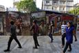 People walk past Bollywood film posters in Mumbai April 14, 2013. Indian cinema marks 100 years since Dhundiraj Govind Phalke's black-and-white silent film "Raja Harishchandra" (King Harishchandra) held audiences spellbound at its first public screening on May 3, 1913, in Mumbai. Indian cinema, with its subset of Bollywood for Hindi-language films, is now a billion-dollar industry that makes more than a thousand films a year in several languages. It is worth 112.4 billion rupees (over $2 billion) and leads the world in terms of films produced and tickets sold. Picture taken April 14, 2013. REUTERS/Vivek Prakash (INDIA - Tags: ENTERTAINMENT SOCIETY) ATTENTION EDITORS: PICTURE 12 OF 20 FOR PACKAGE 'BEHIND THE SCENES OF BOLLYWOOD'. SEARCH 'BEHIND BOLLYWOOD' FOR ALL IMAGES Published: Kvě. 2, 2013, 10:01 odp.