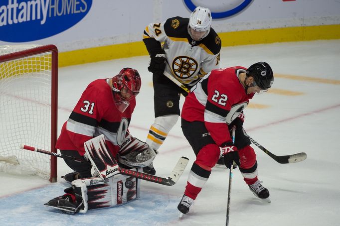 Dec 9, 2019; Ottawa, Ontario, CAN; Ottawa Senators goalie Anders Nilsson (31) makes a save in front of Boston Bruins left wing Jake DeBrusk (74) in the third period at th