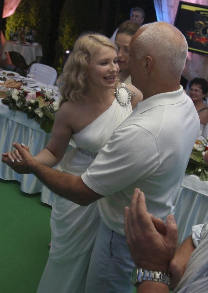 Ukrainian former Prime Minister Yulia Tymoshenko (L) dances with her husband Oleksander on his birthday in Kiev in this June 2010 handout photo. Poland said on Thursday Ukraine's reputation would "suffer dramatically" if no humanitarian solution for the case of jailed ex-premier Yulia Tymoshenko were found, but criticised calls for a boycott of the pending European soccer tournament in Ukraine. REUTERS/Alexander Prokopenko/Yulia Tymoshenko Press Service/Handout (UKRAINE - Tags: POLITICS CRIME LAW) FOR EDITORIAL USE ONLY. NOT FOR SALE FOR MARKETING OR ADVERTISING CAMPAIGNS. THIS IMAGE HAS BEEN SUPPLIED BY A THIRD PARTY. IT IS DISTRIBUTED, EXACTLY AS RECEIVED BY REUTERS, AS A SERVICE TO CLIENTS