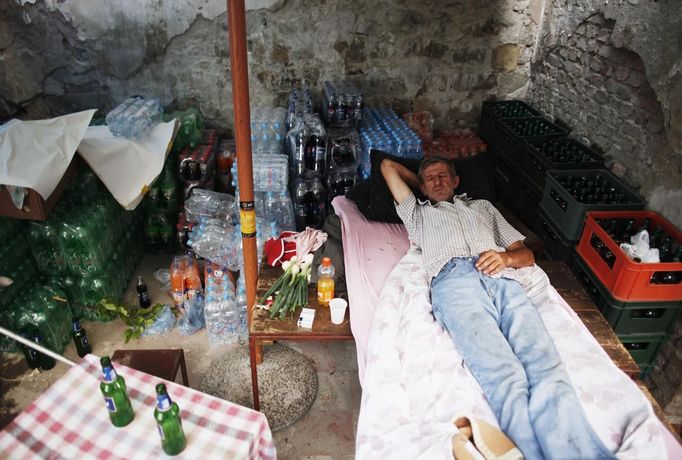 Nedzad Begovic rests in a restaurant in Potocari, near Srebrenica, July 6, 2012. Begovic and Slobodan Radakovic, both war survivors, make a living by putting together a restaurant selling roasted lamb. During the war, Bosnian Serb forces commanded by General Ratko Mladic killed up to 8000 Muslim men and boys in the Srebrenica area. Begovic lost 70 family members and Radakovic lost 10 family members. Picture taken July 6, 2012. REUTERS/Dado Ruvic (BOSNIA AND HERZEGOVINA - Tags: CONFLICT SOCIETY FOOD) Published: Čec. 8, 2012, 3:10 dop.