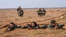 A female fighter of the Kurdish People's Protection Units (YPG) fires a Rocket-propelled grenade (RPG) as she participates in a military training