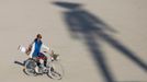 A participant rides past the shadow of the Man during the Burning Man 2012 "Fertility 2.0" arts and music festival in the Black Rock Desert of Nevada, August 29, 2012. More than 60,000 people from all over the world have gathered at the sold out festival, which is celebrating its 26th year, to spend a week in the remote desert cut off from much of the outside world to experience art, music and the unique community that develops.