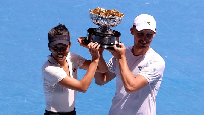 Tennis - Australian Open - Melbourne Park, Melbourne, Australia - January 26, 2024 Poland's Jan Zielinski and Taiwan's Hsieh Su-wei pose with the trophy after winning the