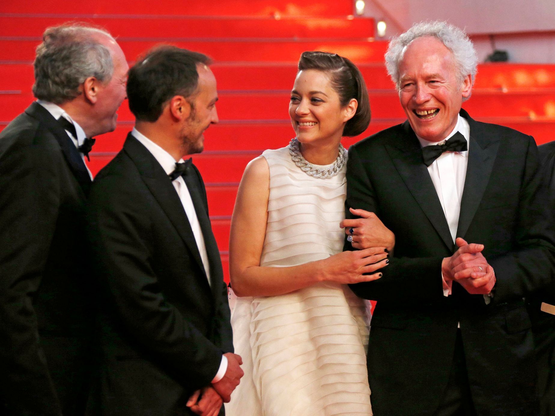 Directors Jean-Pierre and Luc Dardenne, cast members Marion Cotillard and Fabrizio Rongione pose on the red carpet as they leave after the screening of the film &quot;Deux jours, une nuit&quot; at the