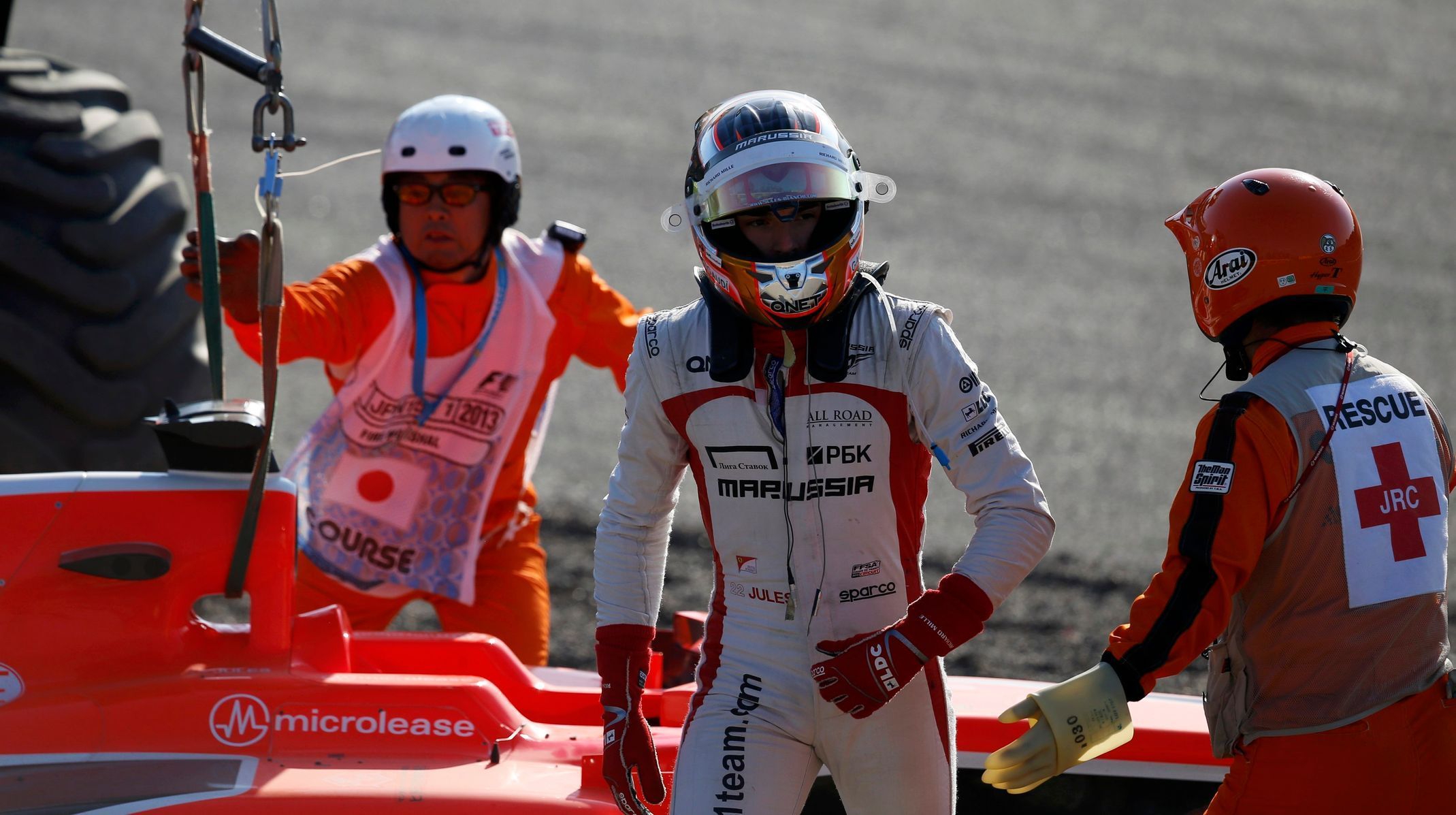Marussia Formula One driver Bianchi of France walks away from his car during the Japanese F1 Grand Prix at the Suzuka circuit