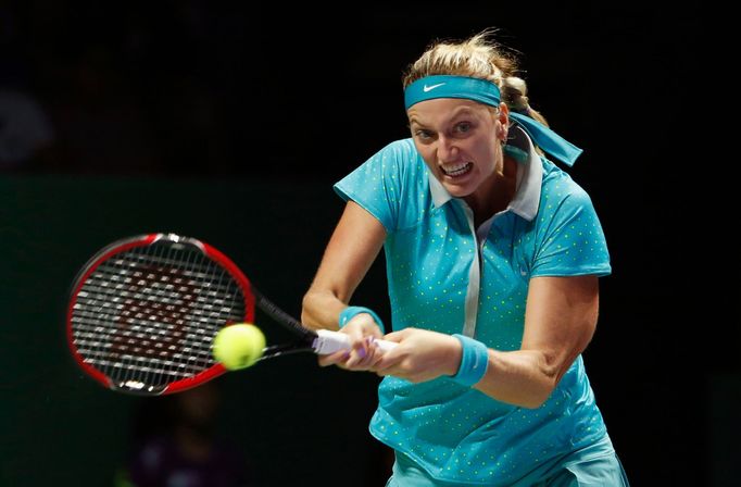 Petra Kvitova of the Czech Republic hits a return to Maria Sharapova of Russia during their WTA Finals singles tennis match at the Singapore Indoor Stadium October 23, 20