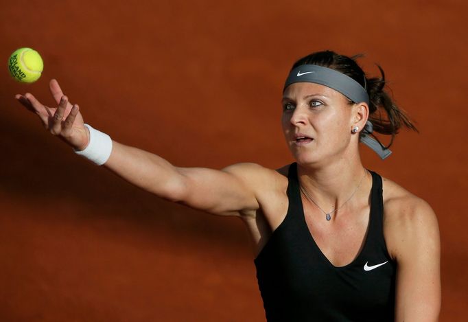 Lucie Safarova of the Czech Republic serves the ball to Mandy Minella of Luxembourg during their women's singles match at the French Open tennis tournament at the Roland