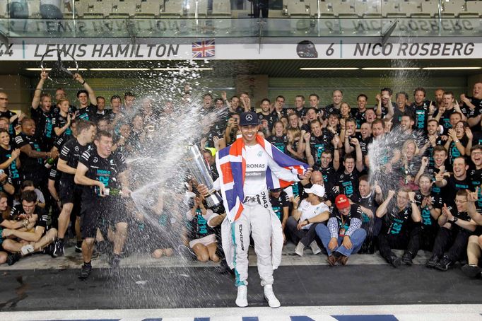 Mercedes Formula One driver Lewis Hamilton of Britain celebrates with his team after winning the Abu Dhabi F1 Grand Prix at the Yas Marina circuit in Abu Dhabi November 2