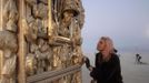 Ruth Kidd explores the art piece "Ego" before sunrise during the Burning Man 2012 "Fertility 2.0" arts and music festival in the Black Rock Desert of Nevada, August 29, 2012. More than 60,000 people from all over the world have gathered at the sold out festival, which is celebrating its 26th year, to spend a week in the remote desert cut off from much of the outside world to experience art, music and the unique community that develops.