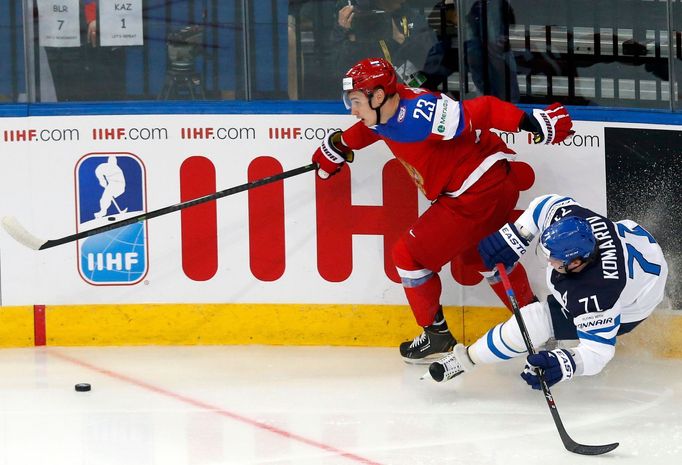 Finland's Leo Komarov (R) falls behind Russia's Dimitri Orlov (L) during the first period of their men's ice hockey World Championship group B game at Minsk Arena in Mins