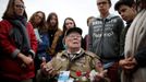 WWII D-Day veteran George Shenkle of the U.S. talks with students from France after a ceremony at Normandy American Cemetery and Memorial