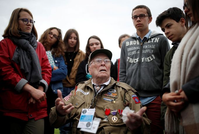 WWII D-Day veteran George Shenkle of the U.S. talks with students from France after a ceremony at Normandy American Cemetery and Memorial