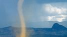 A vortex of swirling dust, known as a "dust devil", rises from the semi-arid bush country near Kaped