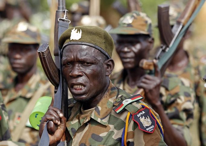 Soldiers of South Sudan's SPLA army shout at a military base in Bentiu