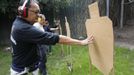 Jaime "Jimmy" Santiago (L), a lower court judge in Manila, with his fellow court judges checks their target cardboard during their shooting practice at a police firing range in Manila March 6, 2013. Santiago, a former police officer who headed a special weapons and tactics (SWAT) unit, favours arming Filipino judges to protect themselves from disgruntled litigants who can't accept decisions and criminal syndicates whose members were sent to jail. There had been cases of shootings inside courtrooms. In photo from L-R: Judge court Jaime Santiago, Judge court Emilio Legazpi III, Judge coourt Jose Lorenzo Dela Rosa and Judge court Armando Yanga. Picture taken March 6, 2013. REUTERS/Romeo Ranoco (PHILIPPINES - Tags: POLITICS CRIME LAW) Published: Dub. 4, 2013, 11:22 dop.