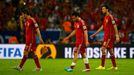 (L-R) Spain's Koke, Santi Cazorla and Sergio Busquets walk off the pitch at the end of their 2014 World Cup Group B soccer match against Chile at the Maracana stadium in