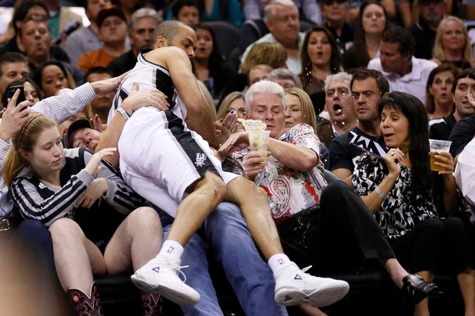 May 8, 2014; San Antonio, TX, USA; San Antonio Spurs guard Tony Parker (9) goes out of bounds and lands on a fan against the Portland Trail Blazers in game two of the sec