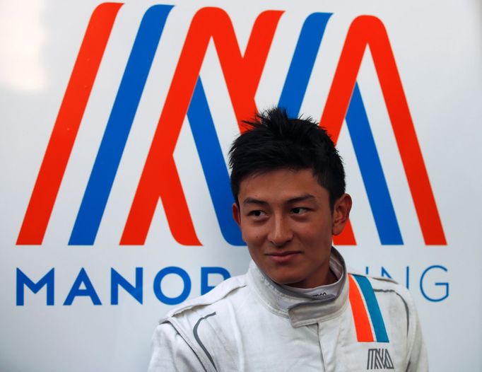 Manor Racing Formula One driver Rio Haryanto of Indonesia stands outside his team's garage after the third testing session ahead the upcoming season at the Circuit Barcel