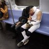 Halloween revellers sleep on the uptown 6 subway train early in the morning in the Manhattan borough of New York