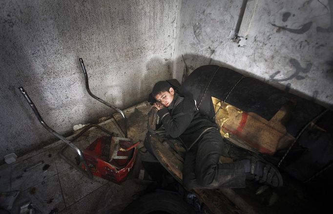 Gaza child labour 2012-02-23 00:00:00 epa03119005 Palestinian 11 year old Anis, sleeps during his rest period after his working repairing a customers car in the town of Beit Lahyia in northern Gaza on 23 February 2012. Reports state that child labor is widespread in the Gaza Strip because of the high rate of poverty and unemployment. Palestinain children leave school and go to work in an attempt to improve their standard of living, for low salaries because of lack of employment opportunities in Gaza. EPA/ALI ALI