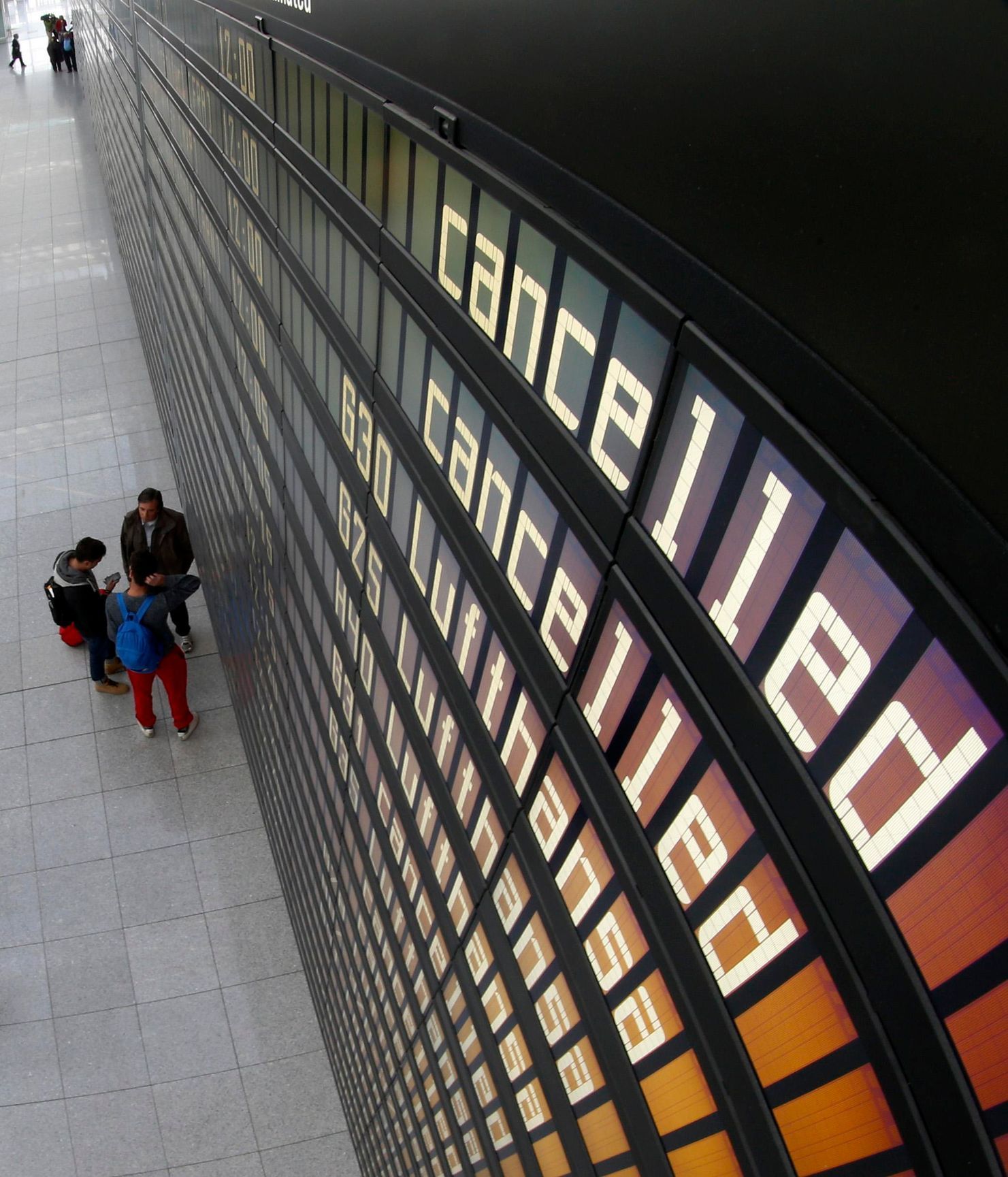 Cancelled flights by German air carrier Lufthansa are pictured on flight schedule board at Munich's airport