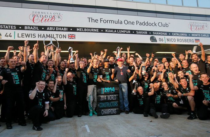 The Mercedes Formula One team pose after winning the 2014 constructors World Championship at the first Russian Grand Prix in Sochi October 12, 2014. REUTERS/Maxim Shemeto