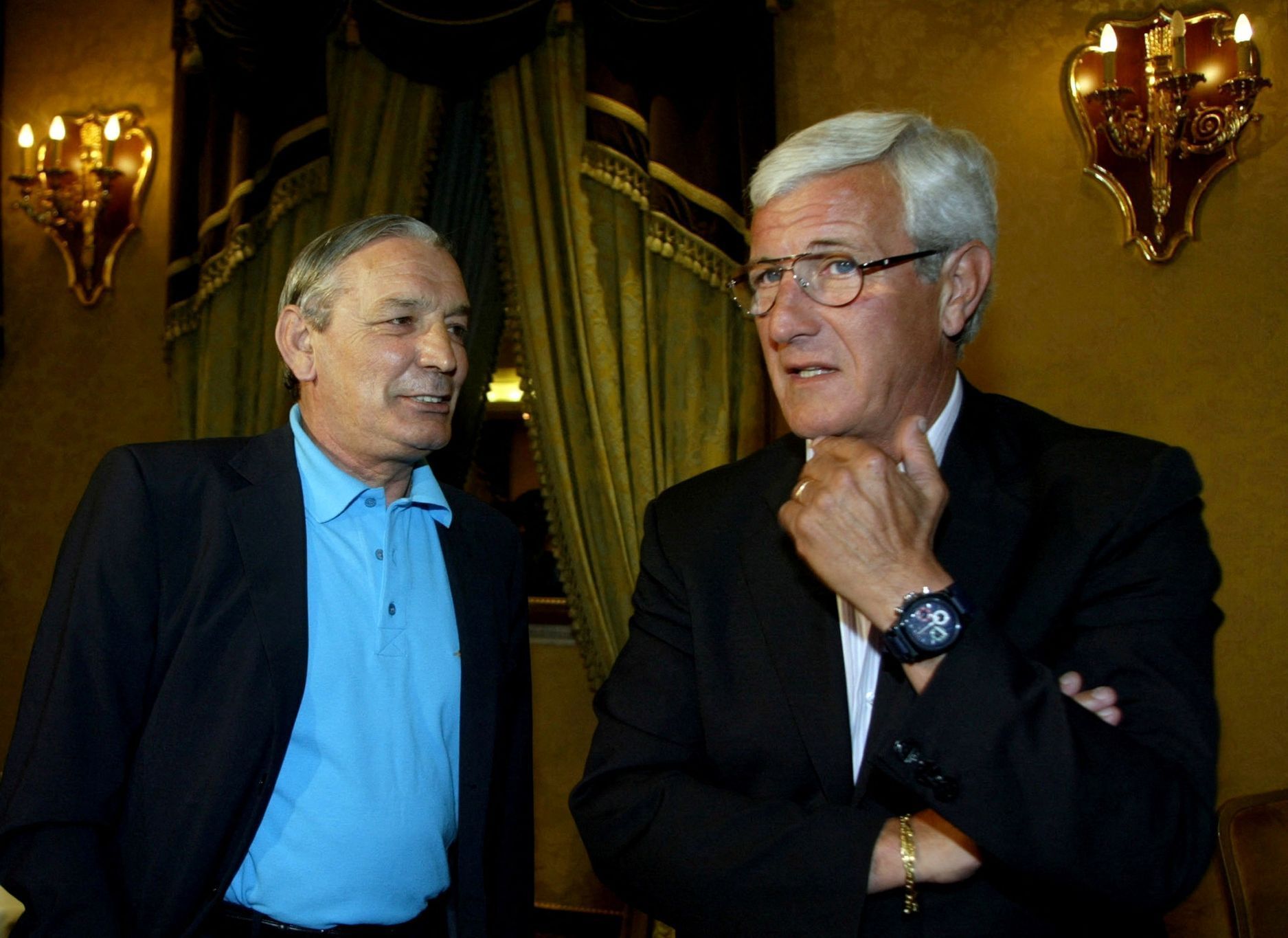 FILE PHOTO: Italy's coach Lippi chats with Riva before news conference in Rome