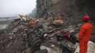 A rescuer looks on as excavators clean up a road which is blocked by a landslide after Saturday's earthquake, in Baoxing county, Sichuan province April 22, 2013. The death toll has risen to at least 188, with more than 11,000 others injured, after an earthquake struck in Lushan county, near the city of Ya'an in the southwestern province of Sichuan on Saturday, Xinhua News Agency reported. REUTERS/China Daily (CHINA - Tags: DISASTER TPX IMAGES OF THE DAY) CHINA OUT. NO COMMERCIAL OR EDITORIAL SALES IN CHINA Published: Dub. 22, 2013, 2:06 odp.