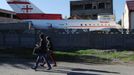 A picture taken on October 29, 2012, shows people walking past a Soviet-era Yakovlev Yak-42 plane turned into a kindergarten in the Georgian city of Rustavi, some 25 km southeast of the capital Tbilisi. Local head teacher Gari Chapidze bought the old but fully functional Yak-42 from Georgian Airways and refurbished its interior with educational equipment, games and toys but left the cockpit instruments intact so they could be used as play tools.