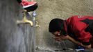 Marathon runner Gladys Tejeda, the first Peruvian athlete who qualified for the 2012 London Olympic Games, washes her face before training at her home in the Andean province of Junin May 15, 2012. A private company will take Gladys' mother Marcelina Pucuhuaranga, 69, to London as part of the "Thank you Mom" program. For Pucuhuaranga, who received her first passport, it will be the first time travelling out of Peru. The program will take about 120 mothers of different athletes around the world to attend the games. Tejeda, the youngest of nine children, returned to her hometown to visit her mother and to focus on training where she will run more than 20 km every day in the highlands (over 4,105 meters above sea level). Picture taken May 15, 2012. REUTERS/Pilar Olivares (PERU - Tags: SPORT ATHLETICS OLYMPICS) Published: Kvě. 17, 2012, 6:20 odp.