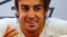 Ferrari Formula One driver Fernando Alonso of Spain speaks with a crew member in his garage during the second practice session of the Bahrain F1 Grand Prix at the Bahrain