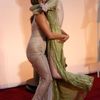 Actresses Aniston and Stone greet each other on the red carpet as they arrive at the 87th Academy Awards in Hollywood