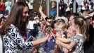 Catherine, the Duchess of Cambridge, reacts as she meets with members of the crowd during a tour of Echo Point in the Blue Mountains town of Katoomba