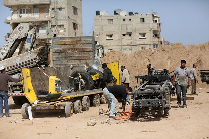 Palestinian workers collect parts of a vehicle entered via a huge tunnels for smuggling cars and spare parts beneath the border between Egypt and southern Gaza Strip in Rafah. by Wissam Nassar.