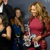 Singer Beyonce poses backstage with three of her four awards during the 2014 MTV Video Music Awards in Inglewood