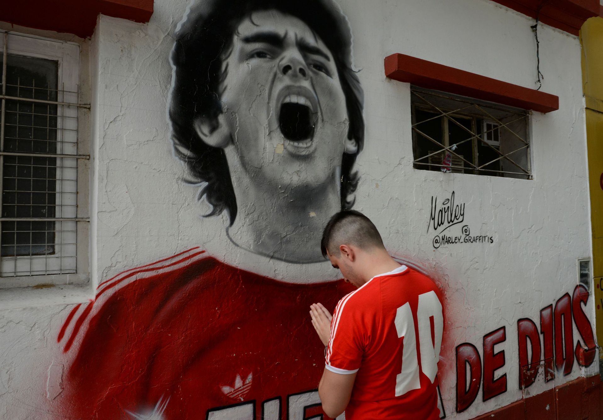 A fan reacts while mourning the death of soccer legend Diego Maradona, outside the Diego Armando Maradona stadium, in Buenos Aires