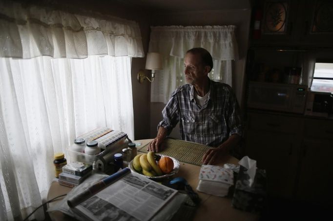 Jack Waddington, 80, sits in his trailer in which he has lived for 13 years, in Village Trailer Park in Santa Monica, California, July 12, 2012. Developer Marc Luzzatto wants to relocate residents from the trailer park to make way for nearly 500 residences, office space, stores, cafes and yoga studios, close to where a light rail line is being built to connect downtown Los Angeles to the ocean. Village Trailer Park was built in 1951, and 90 percent of its residents are elderly, disabled or both, according to the Legal Aid Society. Many have lived there for decades in old trailers which they bought. The property is valued at as much as $30 million, according the LA Times. Picture taken July 12, 2012. REUTERS/Lucy Nicholson (UNITED STATES - Tags: REAL ESTATE BUSINESS SOCIETY POLITICS) Published: Čec. 14, 2012, 7:33 dop.