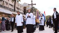 Procesí otevírají ministranti nesoucí kříž a svíci.