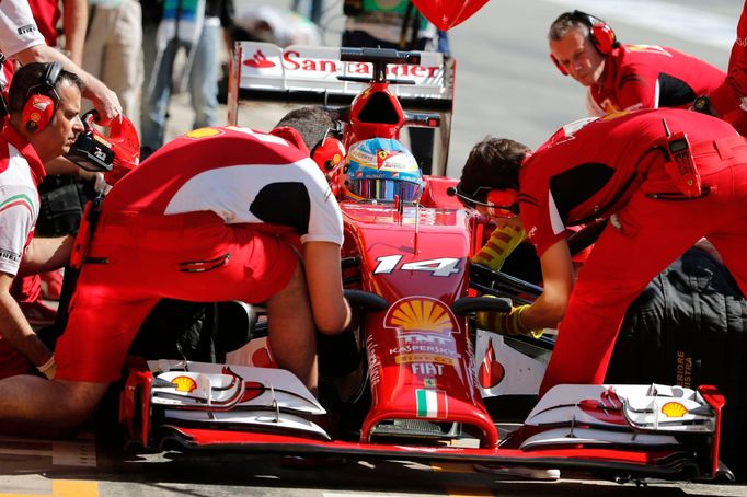 Ferrari Formula One driver Fernando Alonso of Spain performs a pit stop during the first practice session of the Spanish F1 Grand Prix at the Barcelona-Catalunya Circuit