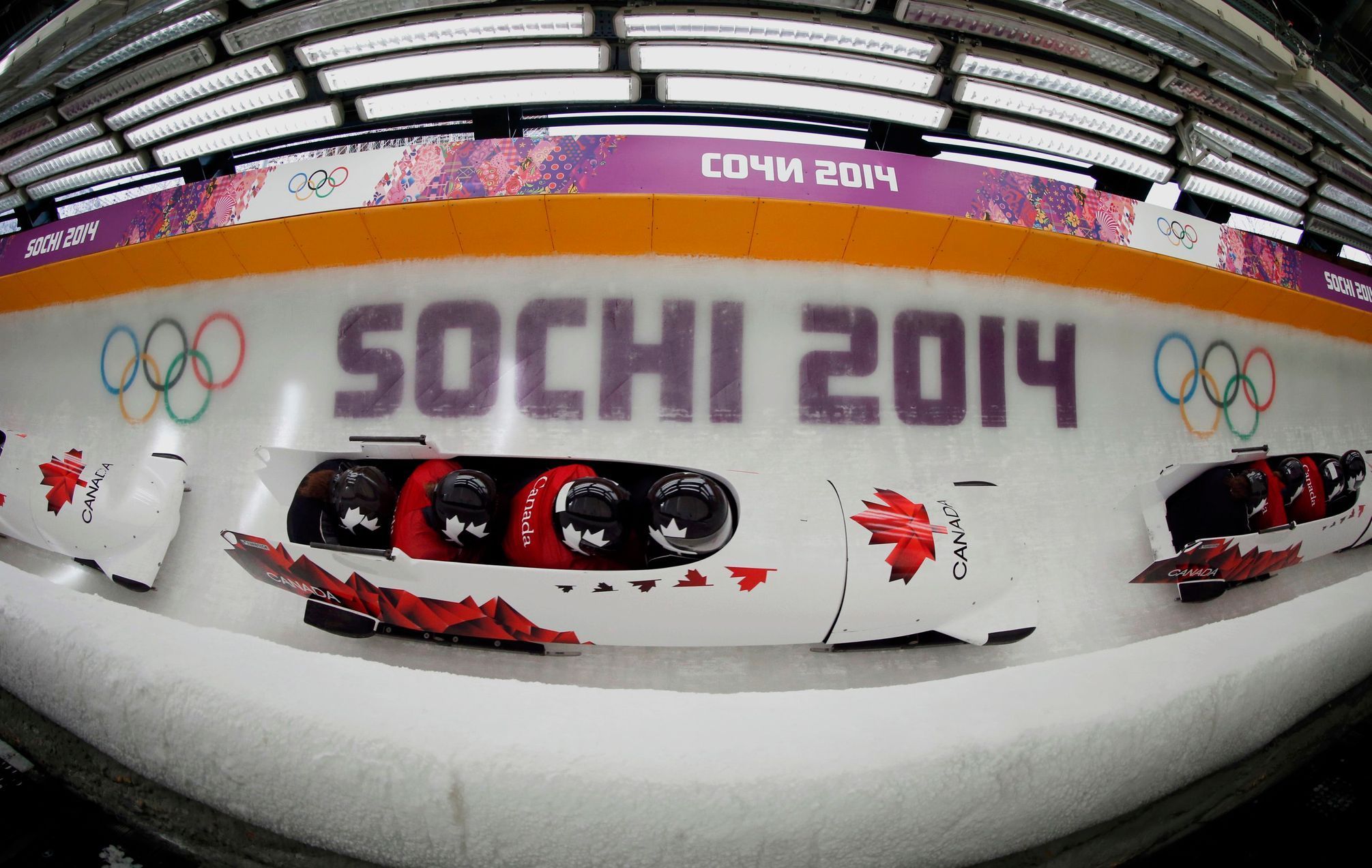 Canada's pilot Spring and his teammates speed down the track during a four-man bobsleigh training session in Rosa Khutor, during the Sochi 2014 Winter Olympics