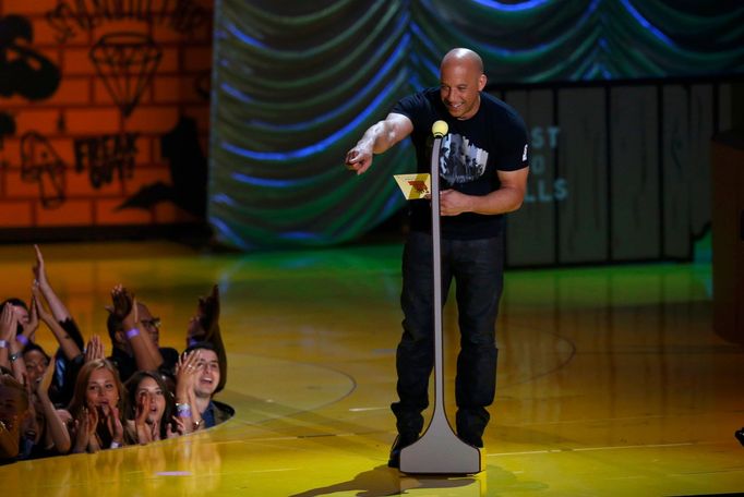 Actor Vin Diesel presents an award at the 2015 MTV Movie Awards in Los Angeles