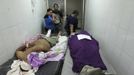 People observe the dead body of a family member who had died of gunshot wounds after being attacked by a gang while a patient lying on a stretcher covers his face at the emergency ward of a local hospital in San Pedro Sula March 20, 2013. San Pedro Sula, the country's second largest city after Tegucigalpa, has a homicide rate of 169 per 100,000 people and was named the world's most violent city for a second year in a row. Lax laws allow civilians to own up to five personal guns. Arms trafficking has flooded the country with nearly 70% illegal firearms. 83.4% of homicides are by firearms, compared to 60% in the United States. Picture taken March 20, 2013. REUTERS/Jorge Cabrera (HONDURAS - Tags: CRIME LAW CIVIL UNREST HEALTH) ATTENTION EDITORS: PICTURE 19 OF 39 FOR PACKAGE 'GUN CULTURE - HONDURAS' SEARCH 'HONDURAS GUN' FOR ALL IMAGES Published: Dub. 5, 2013, 11:14 dop.