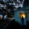 Russell Meadows, left, helps neighbor Rob Muller board up his home ahead of Hurricane Florence in Morehead City, N.C.