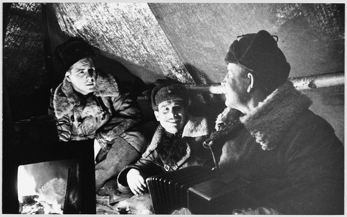 SOLDIERS IN DUG-OUT Soviet soldiers entertain themselves in a dug-out. Date: 1942-43 Source: Unattributed photograph in Meledin Collection