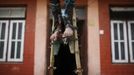 Feet of Drumpal Choudhary, 11, tied with a wooden pole are pictured as he performs his trick at the streets of Kathmandu August 15, 2012. Drumpal, together with his brother, Gchan, and sister, Shivani, came to Kathmandu from India 5 years ago. They earn their living by performing tricks on the streets of Kathmandu. According to Drumpal, Shivani's older brother, they earn around $10 a day by performing tricks, which is not enough to feed their 10-member family living together in a small hut without a proper toilet or any basic needs. REUTERS/Navesh Chitrakar (NEPAL - Tags: SOCIETY POVERTY IMMIGRATION) Published: Srp. 15, 2012, 4:19 odp.