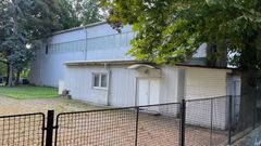Ruské středisk vědy a kultury skrývá na zahradě obří nepovolenou stavbu - velkou plechovou halu (červenec 2025).