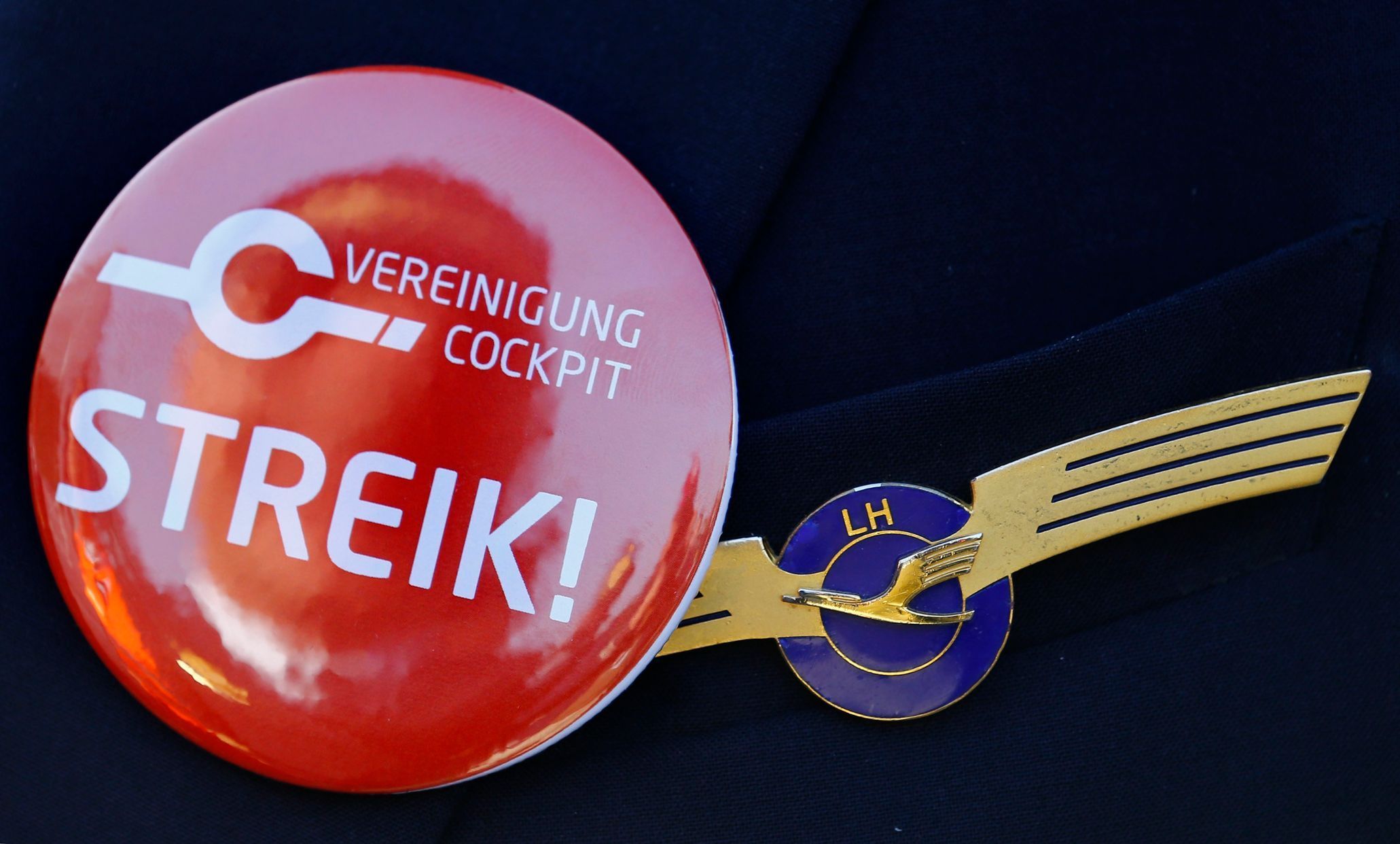 Lufthansa pilot wears badge reading &quot;strike&quot; on his uniform as he takes part in a demonstration at Fraport airport in Frankfurt